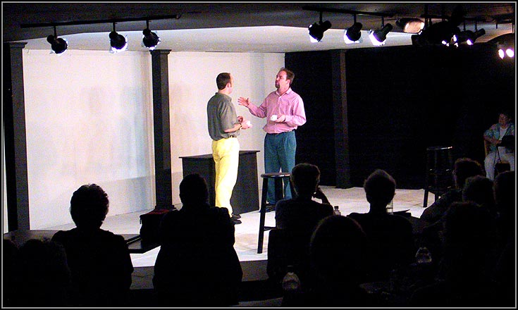 Yvan (Matthew Lawler) and Serge (Corey Patrick) argue over Marc's taste in art.