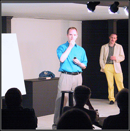 Marc (Craig Bentley) takes homeopathic medicine to calm himself as Serge (Corey Patrick) lectures him about his taste in art.