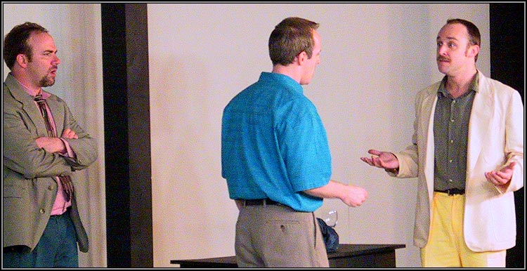 Serge (Corey Patrick) desperately asks his erstwhile friend Marc (Craig Bentley) why it is impossible to love his painting; Yvan (Matthew Lawler) looks on.