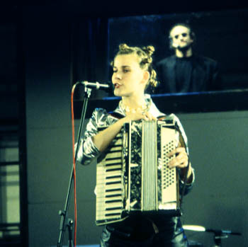 Sylvie (Amy Cronise) plays and sings Walking on the Bottom of the Sea.