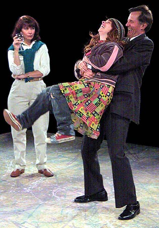 Greg (Stephen Bradbury) plays with his newfound stray dog Sylvia (Kathryn Blume) while his wife Kate (Betsy Jessie) looks on in disbelief.