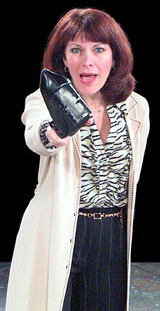 Kate (Betsy Jessie) threatens Sylvia with her chewed-up shoe.