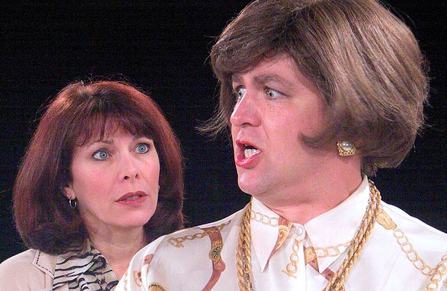 Phyllis (John Alexander) gives Kate (Betsy Jessie) a bit of advice about how to handle a dog.