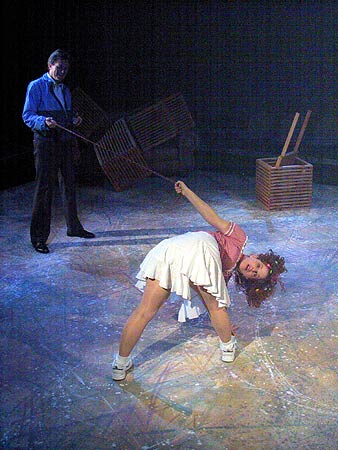 Sylvia (Kathryn Blume) violently chases a cat while Greg (Stephen Bradbury) tries to restrain her.