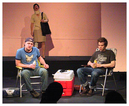 Bandaged Woman (Pat Champon) yells up to Max (Corey Patrick) and Frank (Joshua Alscher) on the rooftop demanding that they come down.